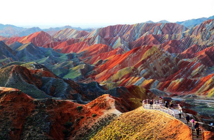 Without going into the geological jargons, eye candy is what would best describe the Zhangye Danxia Landform. It is literally a massive piece of art that spans more than 400 square kilometers in the Linze and Sunan counties of the Gansu Province in northwest China. A canvas cloth would envy the rolling hills and landscapes painted with all colors imaginable. It is as though either an artist had accidentally spilled his color palette on it and let it drip or purposely created this multicolored masterpiece. There are several danxia landforms in China but this one in Zhangye is known as the largest and the most typical, and referred by geologists as the “window lattice and palace-shaped danxia topography”. 